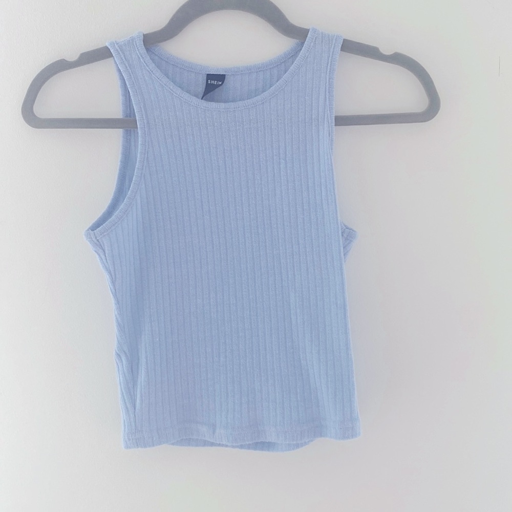 Light blue tank top that’s short but not cropped.
